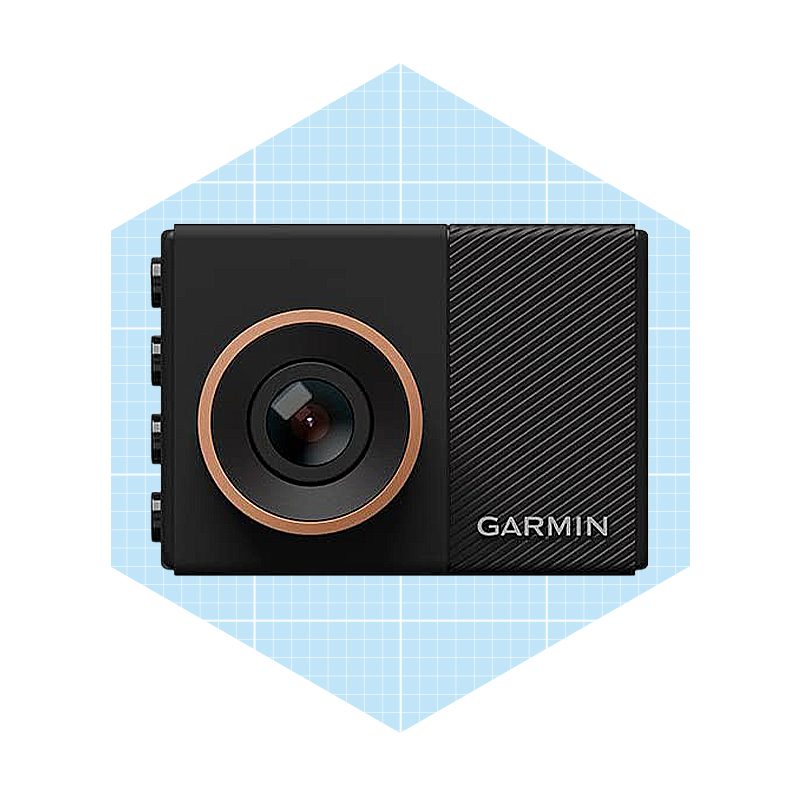 A compact black camera with a circular lens captures images, positioned against a light blue grid background. Its branding is visibly marked "GARMIN."