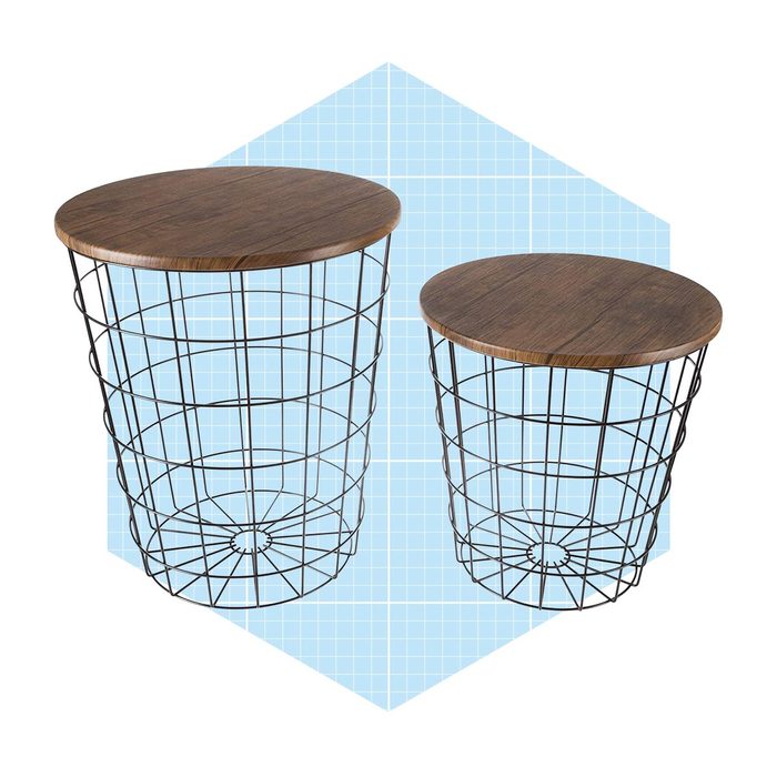 Two wire-frame tables with wooden tops sit on a light blue grid-patterned background. The larger table is next to a smaller one.