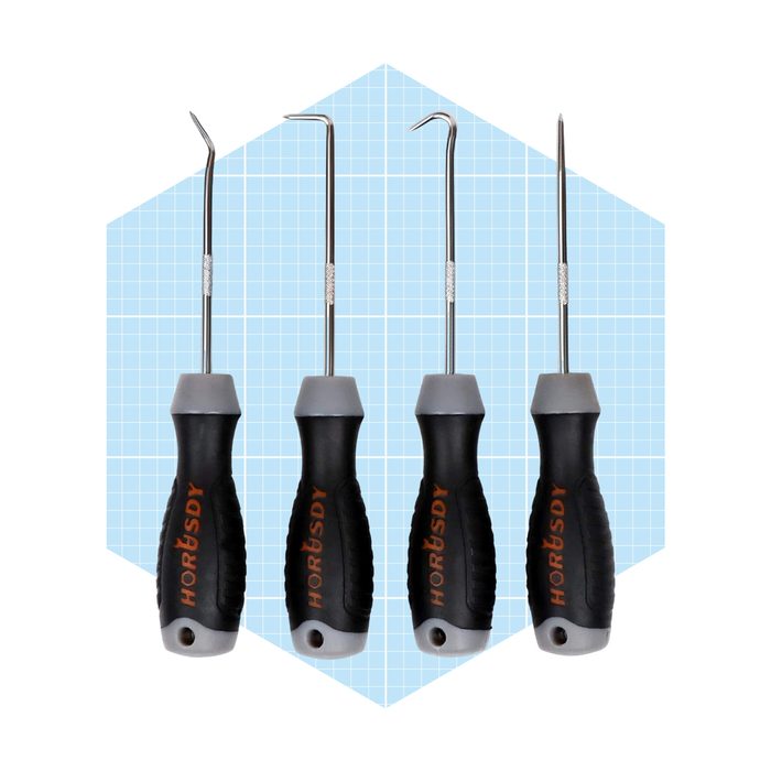 Four precision tools with curved metal tips sit upright against a light blue grid background, designed for intricate work in crafting or repairs.