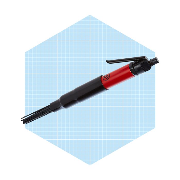 A black and red pen-like tool extends thin bristles, designed for cleaning or applying, set against a light blue grid background.