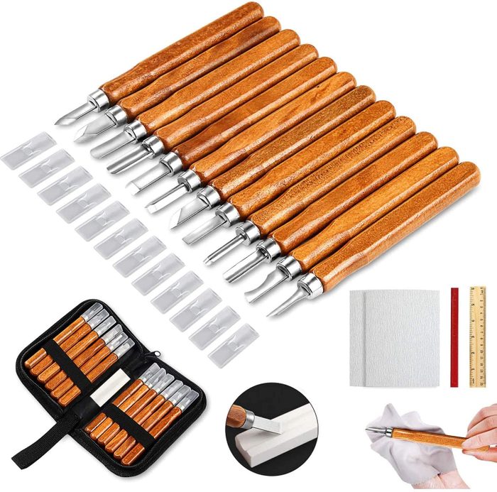 A set of carving tools with wooden handles is displayed, alongside replacement blades and crafting materials, suggesting preparation for detailed creative work.