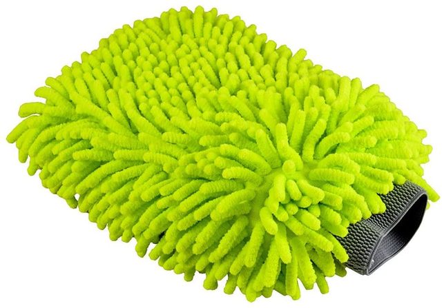 A bright green, fuzzy cleaning mitt sits on a flat surface, featuring textured strands designed to attract dust while providing a comfortable grip for users.