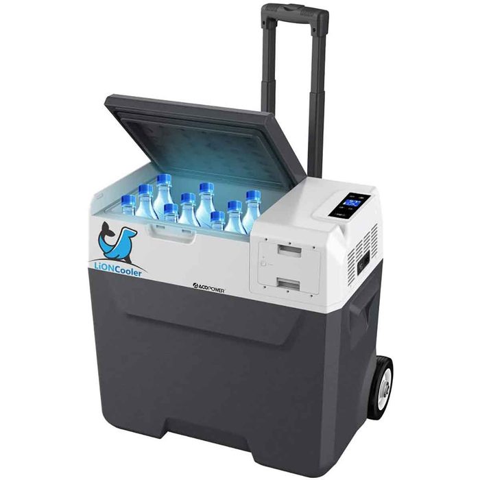 A portable cooler with a handle, open lid displaying several water bottles inside, positioned for easy transport; features a digital display on the side.