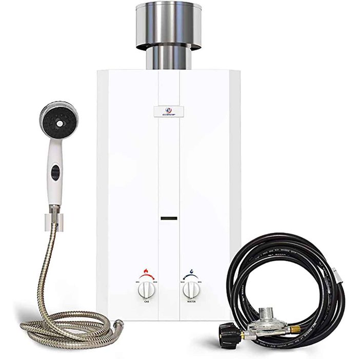 A white gas water heater stands with a showerhead and hoses attached; it heats water on demand for bathing or cleaning in various environments.