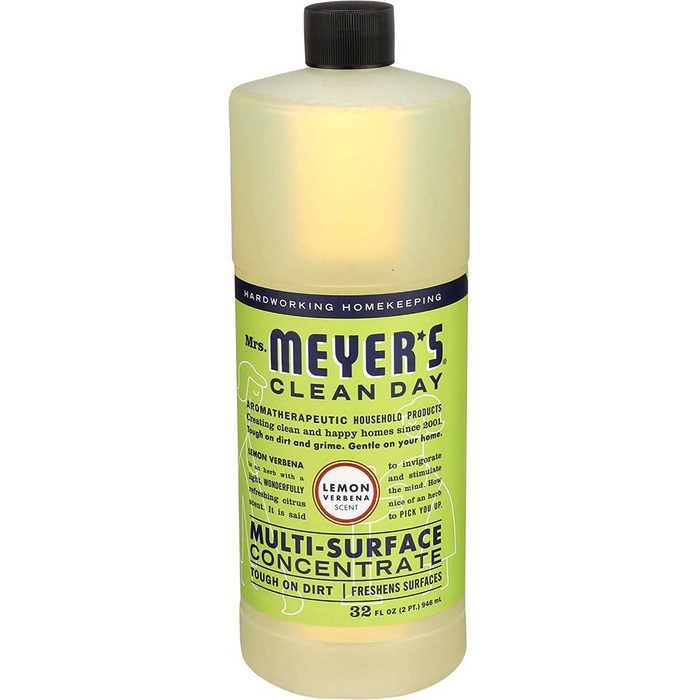 A bottle of multi-surface cleaner stands upright. It contains a lemon verbena-scented solution, designed for cleaning dirt and freshening surfaces in homes.