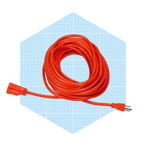An orange extension cord is coiled and arranged neatly, positioned against a light blue grid-patterned background.