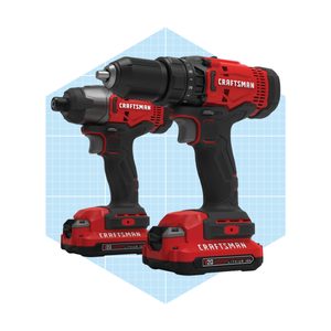 Two red Craftsman power drills are displayed side by side, showcasing their ergonomic design against a light blue grid background.