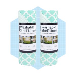 Two rolls of washable shelf liners with a geometric pattern are displayed against a soft blue grid background, emphasizing their design and functionality for shelves.