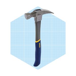 A hammer stands upright with a metal head and a textured blue and yellow handle, set against a light blue grid-patterned background.