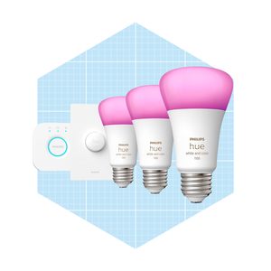 Three pink smart light bulbs are arranged alongside a control device, set against a light blue grid background. They are designed for customizable lighting.