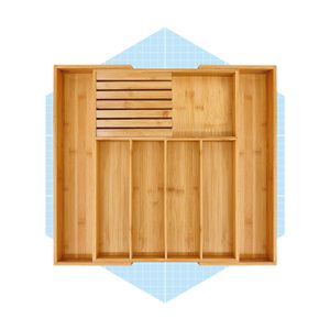A wooden organizer with multiple compartments rests on a light blue grid background, designed for sorting utensils or small items.