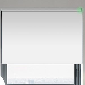 A roller blind covers a window, partially blocking sunlight in a room with a neutral wall color, creating a calm atmosphere.