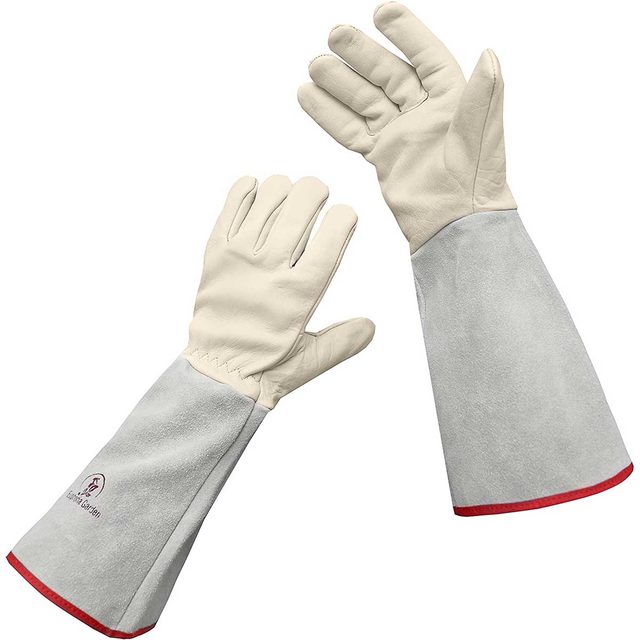 Protective gloves are raised, showcasing their soft leather palms and extended suede cuffs. The backdrop is plain, emphasizing the gloves' design and functionality.