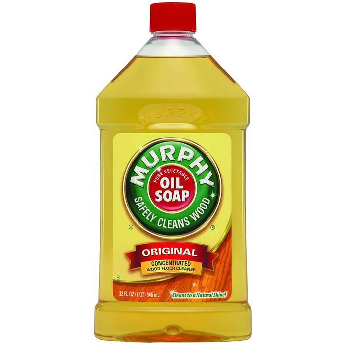 A transparent bottle filled with yellow liquid presents 