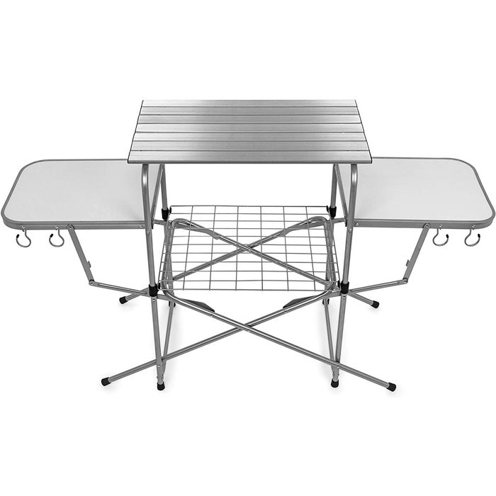 A foldable outdoor kitchen table with a slatted top, two side tables, and a lower wire shelf, designed for cooking or preparation in various settings.