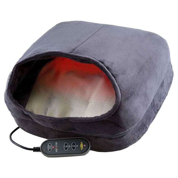 A plush, square heating pad with an open cavity emits warmth, connected by a cord to a remote control for temperature adjustments.