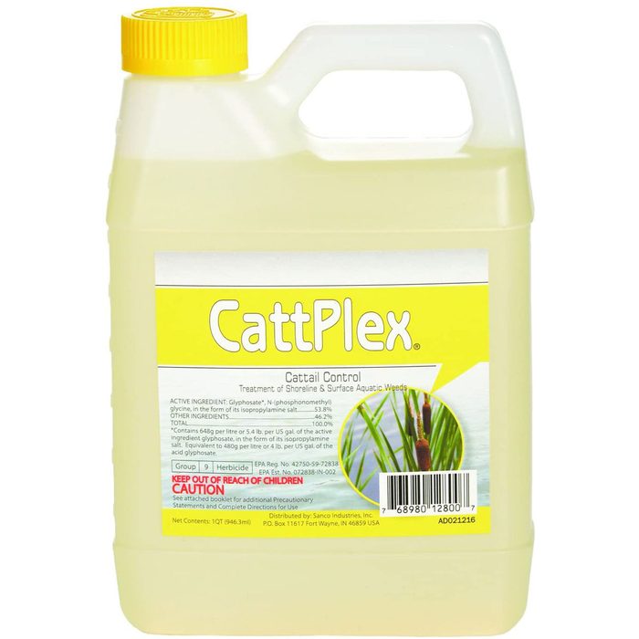 A plastic container with a yellow cap holds a liquid herbicide labeled 