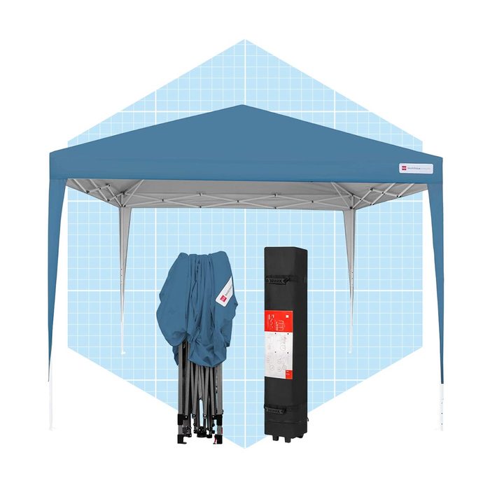 A blue pop-up tent stands upright, with its folded structure and carrying bag displayed beside it, set against a light blue grid background.