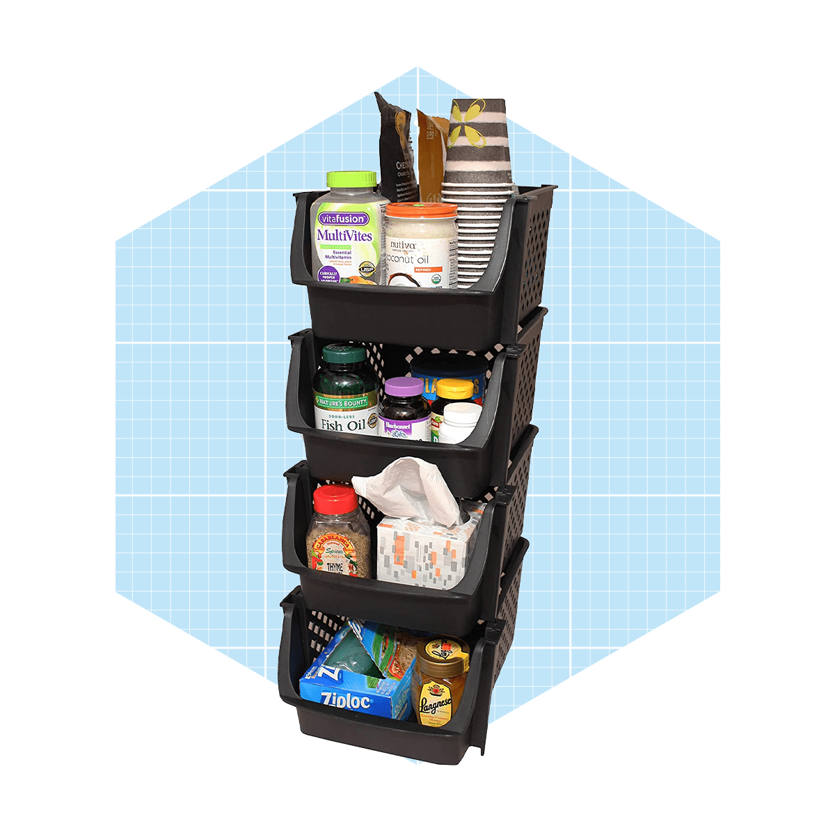 A stack of four black storage baskets contains various food items and supplements, set against a light blue grid background.