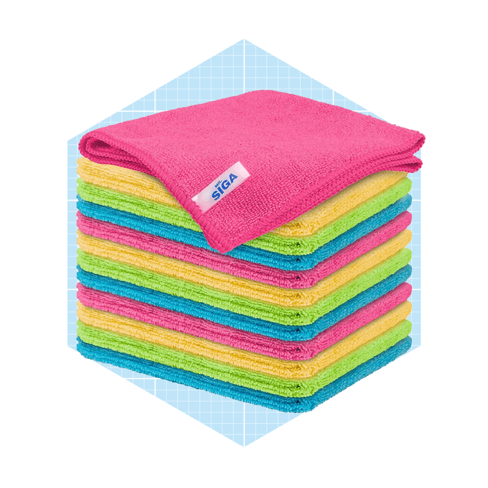 Colorful microfiber towels are neatly stacked, with a top pink towel. The background features a light blue grid pattern, enhancing the organized presentation.
