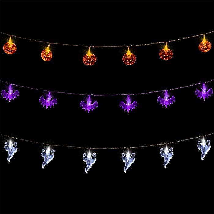 Colorful Halloween-themed string lights featuring orange pumpkins, purple bats, and white ghosts illuminate against a black background, creating a festive atmosphere.
