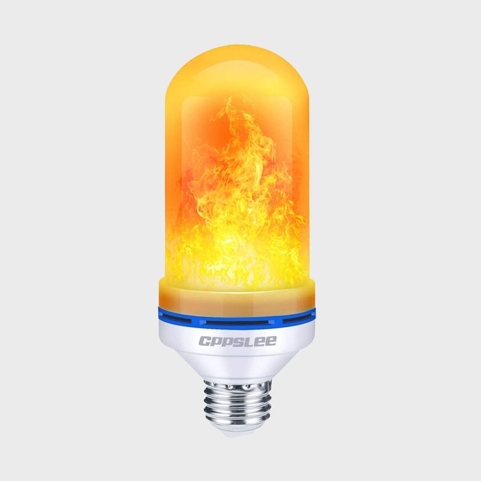 A light bulb emits vibrant orange flames, providing a fiery glow. It features a cylindrical design with a white base and blue accents, set against a neutral background.