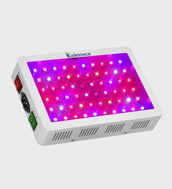 A rectangular light panel emits various colored LEDs, providing illumination. It features control buttons and a power socket, typically used in wellness or plant growth contexts.