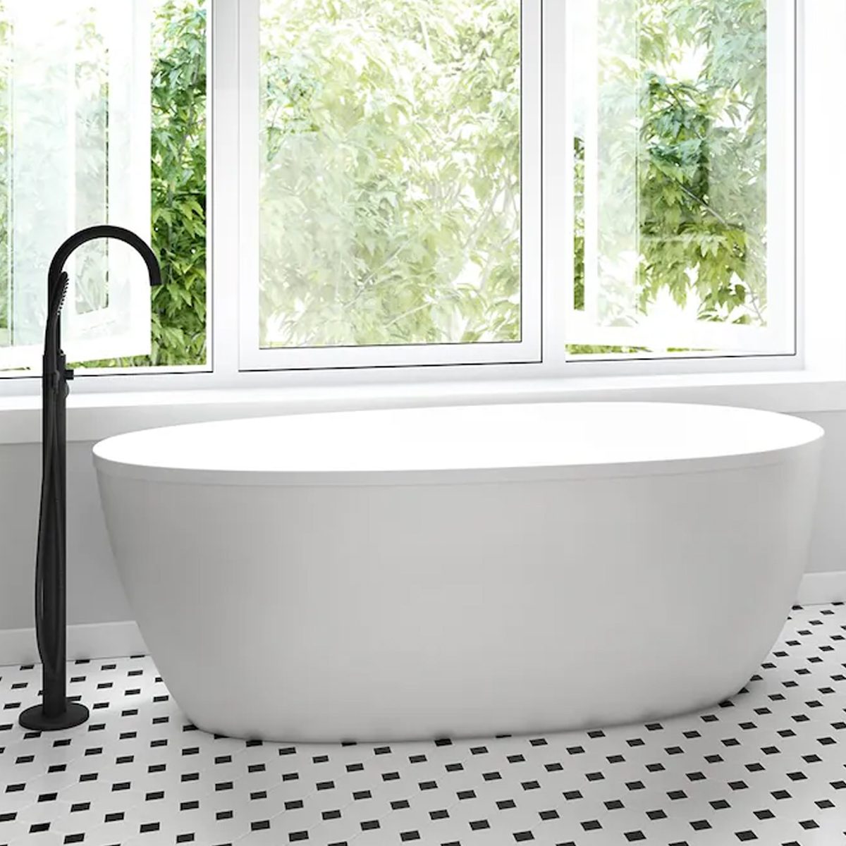 A modern white bathtub sits on a patterned floor, next to a sleek black faucet, with large windows revealing greenery outside.