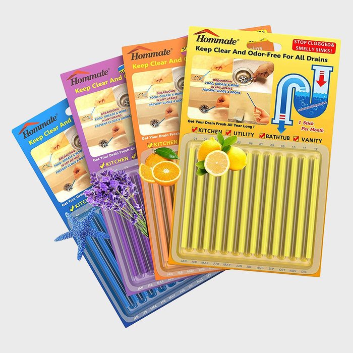 Colored drain cleaner sticks are arranged in packages, promoting odor-free drains for various household areas, featuring images of a sink and fruits.