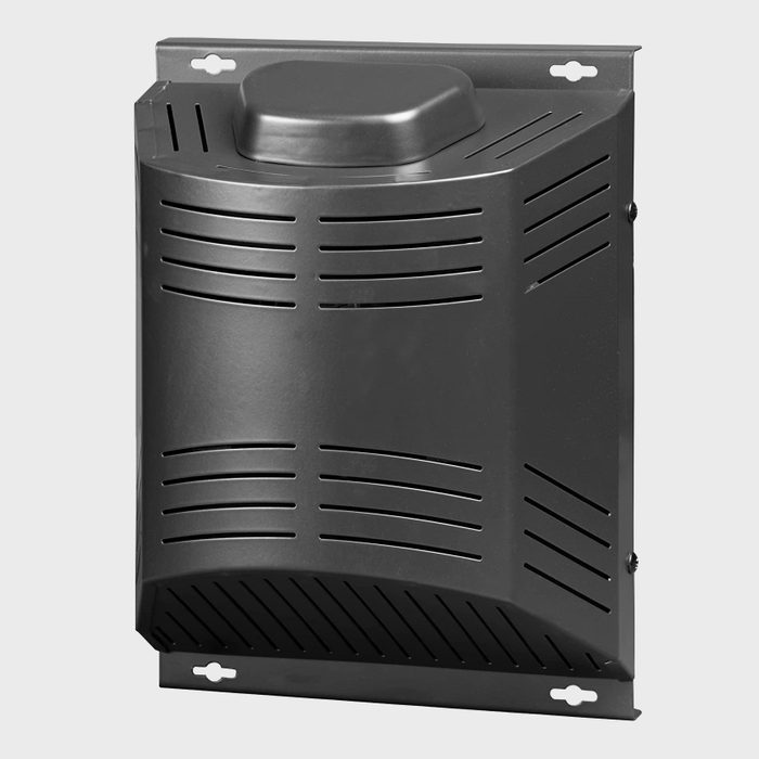 A black wall-mounted vent cover facilitates air circulation, featuring ventilation slits and a rounded upper section, set against a neutral background.
