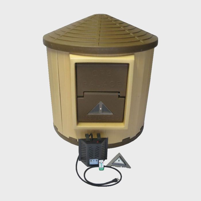 A beige, conical structure with a textured lid displays a secured front panel, while an electronic base unit emits nearby cables, situated on a neutral background.