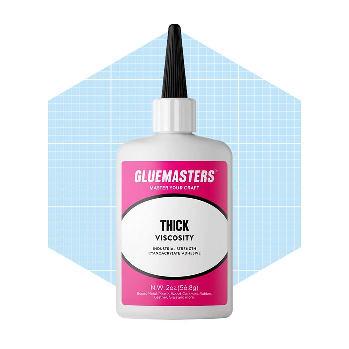 A bottle of glue stands upright, labeled as 