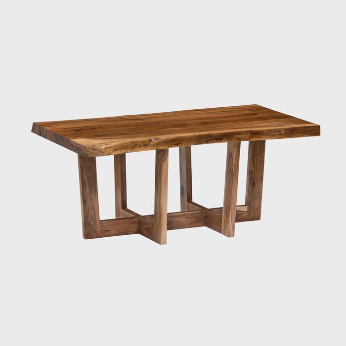 A wooden table with a rustic design stands on four sturdy legs, showcasing natural grain patterns, typically used in dining or living spaces.