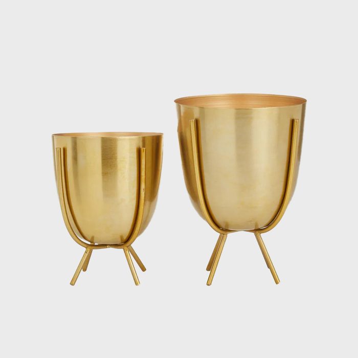 Two shiny gold planters with three legs each stand side by side, one larger than the other, against a plain white background.