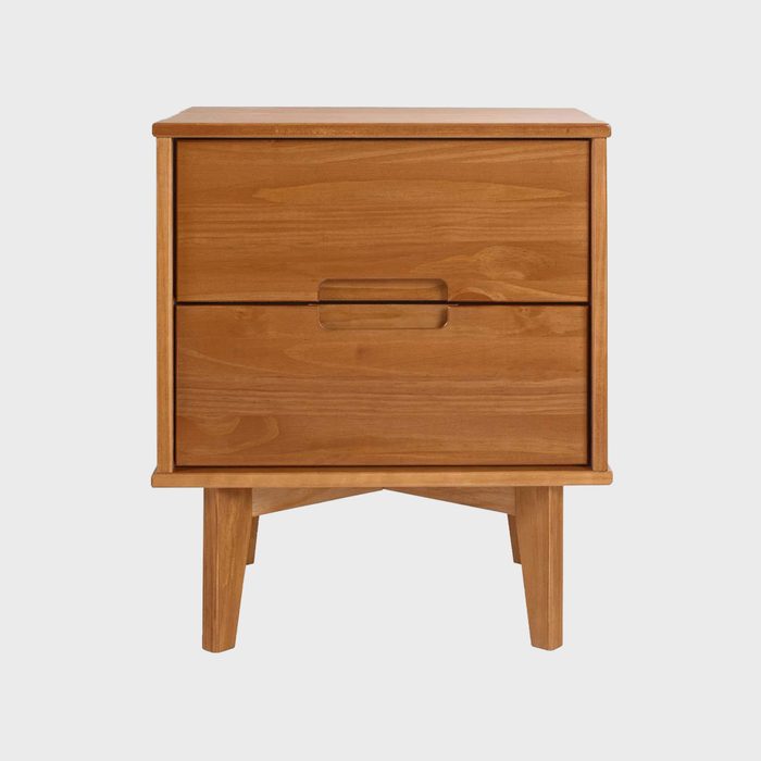 A wooden nightstand stands upright, featuring two drawers with handles, situated on angled legs against a plain white background.