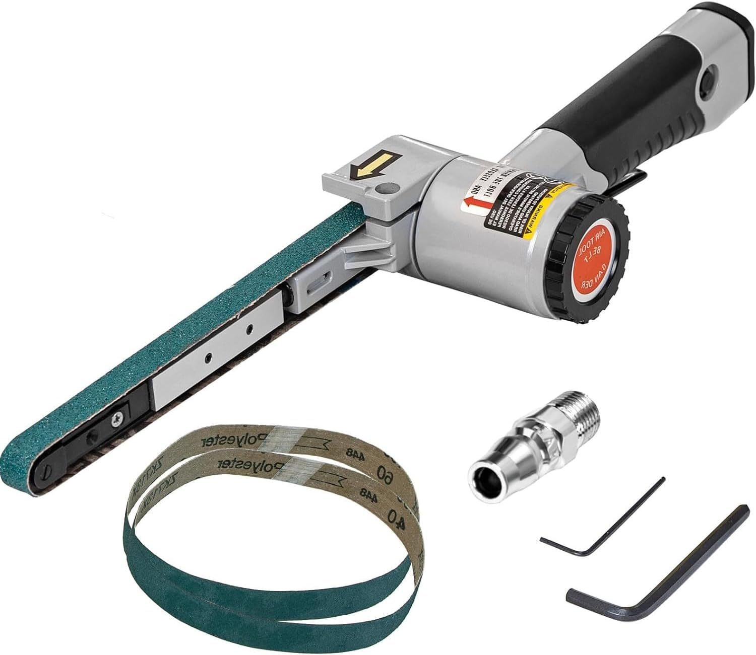 A belt sander, equipped with a sanding belt and accessories, is poised for use, indicating a workspace for shaping or smoothing materials.