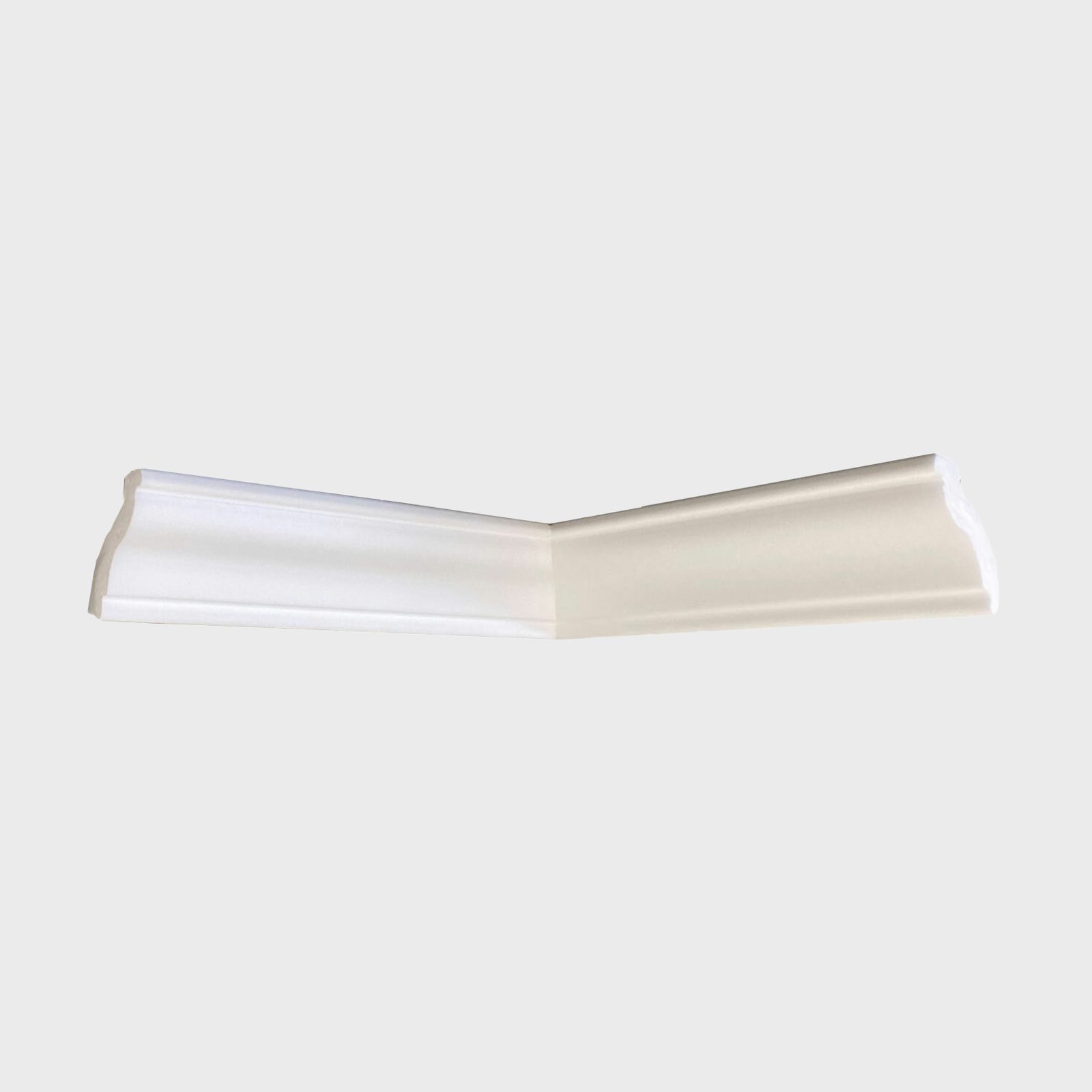 A white molding piece lies diagonally, showcasing its elegant curves, on a neutral background, typically used for decorative trim in interior design.