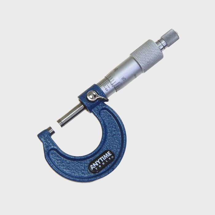 A blue micrometer measures small dimensions with a graduated scale, positioned against a plain white background, emphasizing precision in measuring tools.