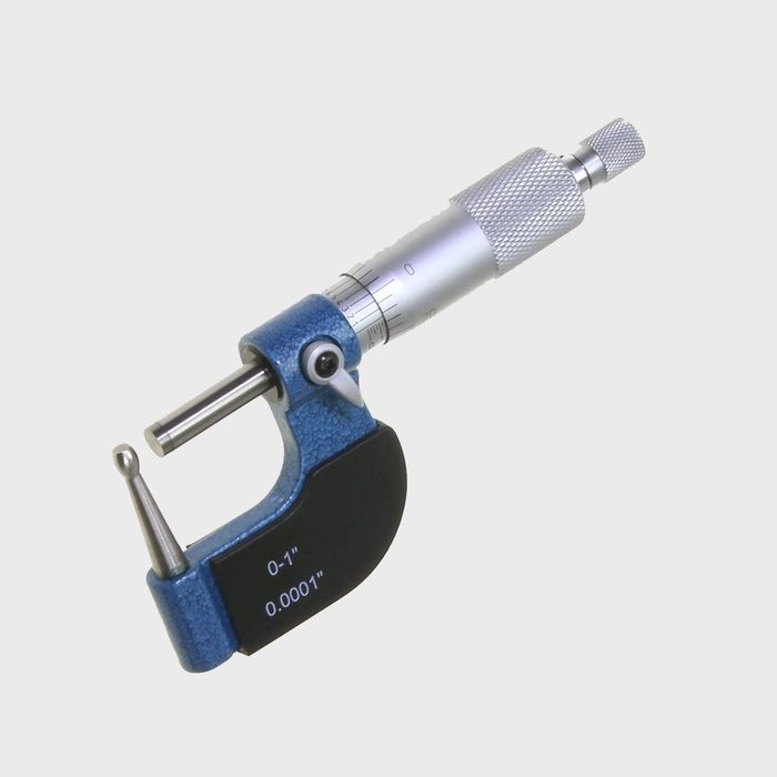 A blue micrometer measures small dimensions, featuring a cylindrical shaft, a textured grip, and calibrated markings for precision in a neutral background.