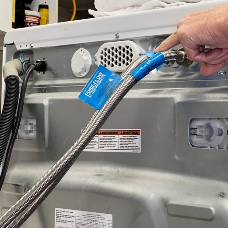 Unscrew water hoses from back of washer