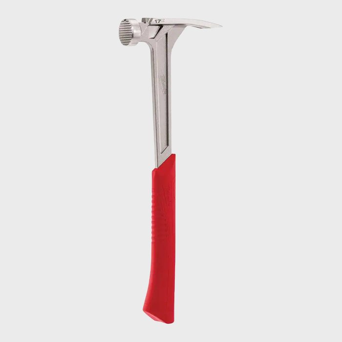 A metal hammer with a red rubber grip stands upright, featuring a flat striking face and a curved claw for pulling nails.