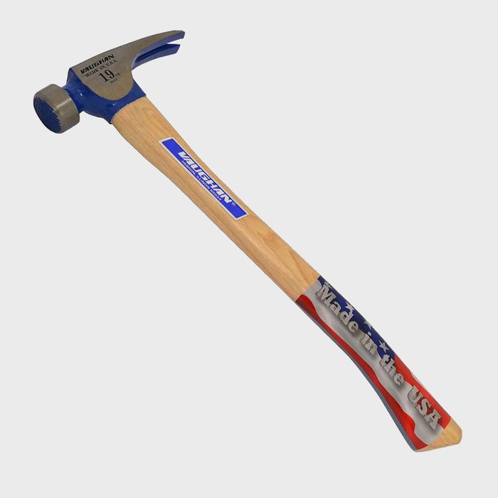 A metal-headed hammer is angled slightly, resting on a light wooden handle; it features blue branding and a design indicating it was made in the USA.