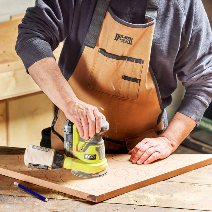 cutting a piece of wood with pencil marks