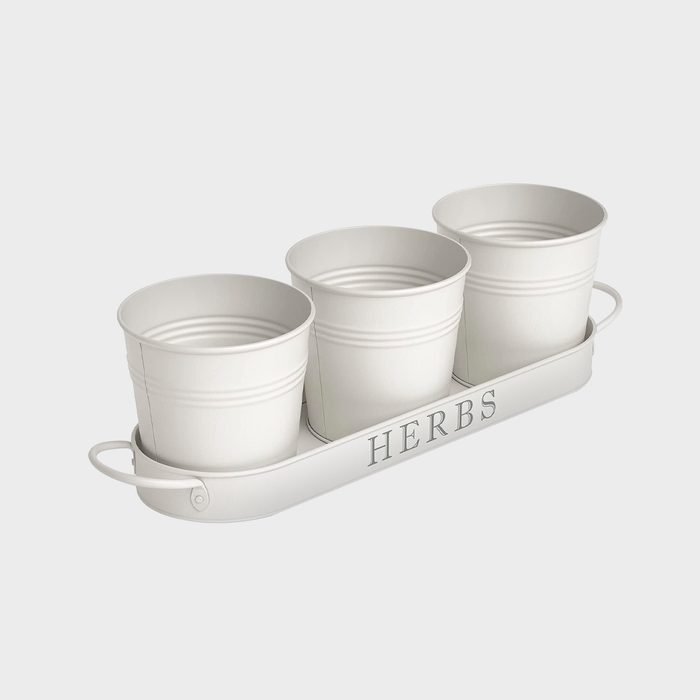 Three white metal pots arranged on a tray labeled 