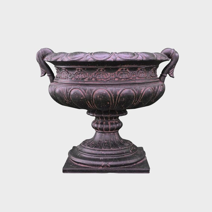 A decorative urn with ornate detailing and two handles is positioned upright on a square base, showcasing its classic design against a neutral background.