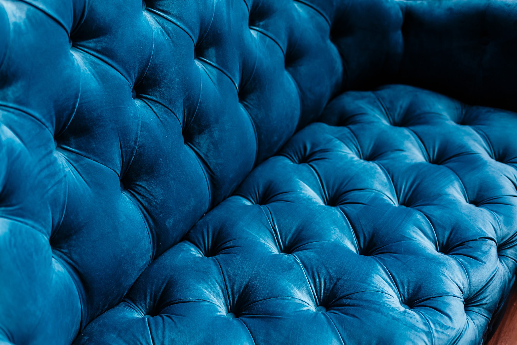 Velvet couch background texture with sunken buttons