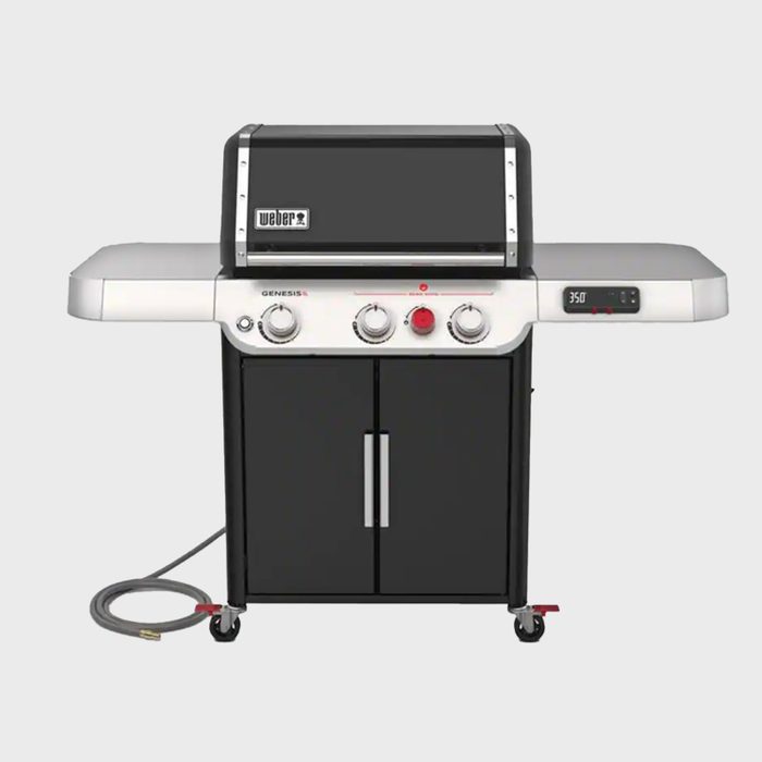 A gas grill with two side tables and controls is set for cooking at 350°F. It features storage cabinets and a gas line connected.
