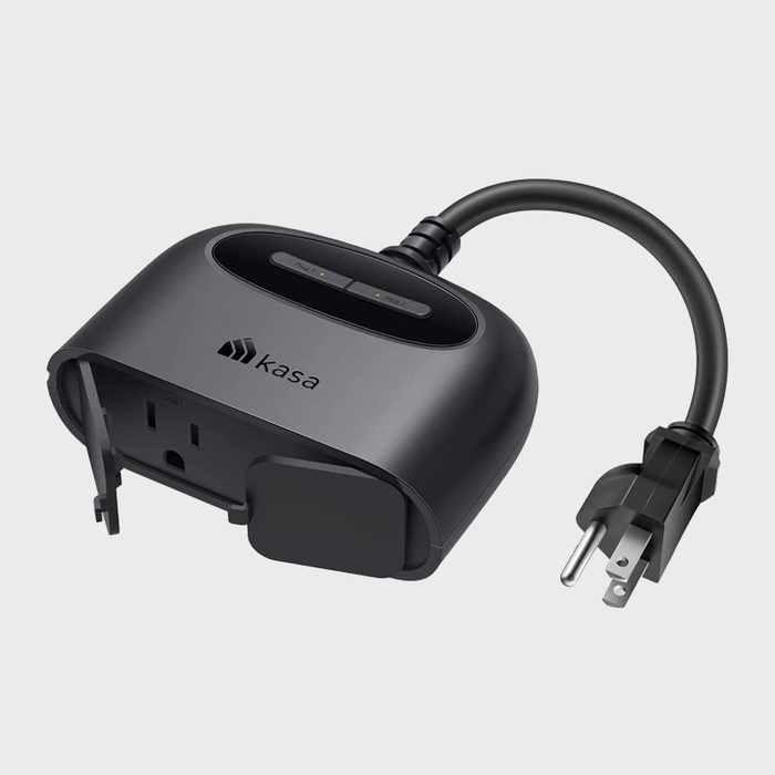 A black smart plug, featuring buttons on top, is connected to a power cord, designed for home automation in electrical outlets.