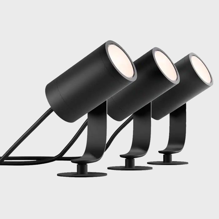 Three cylindrical black lights are mounted on sleek stands, positioned to illuminate a space against a neutral gray background.