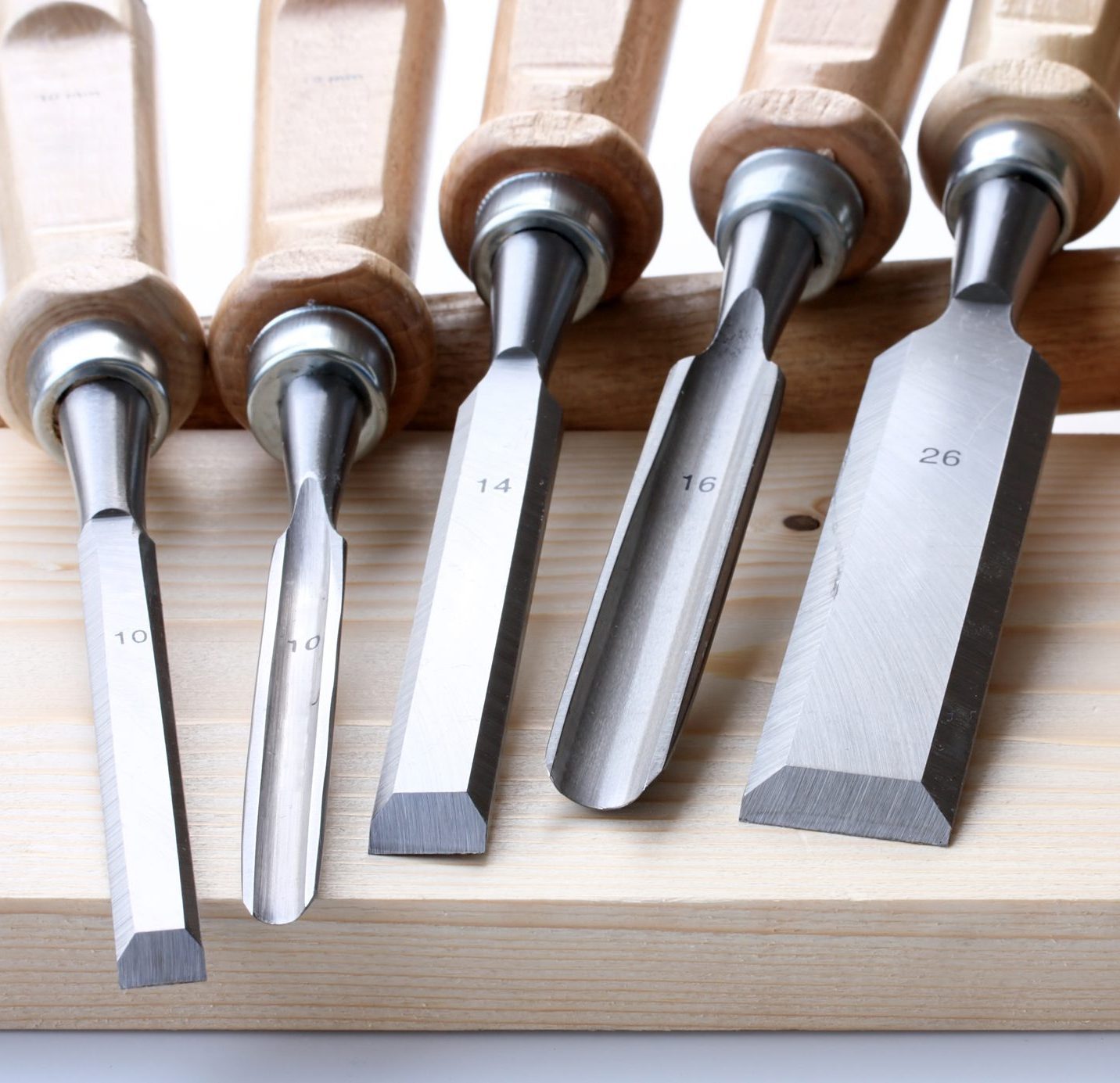 hammer, set of chisels and wooden plate